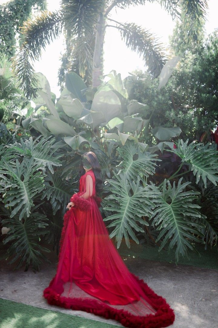 Red Tulle Robe with Feather Trim (Category: Evening dresses & gowns) located in Taguig. Submitted by chicstyle (Listing ID 1422819417, Image 2). Description: - Elegant red tulle robe - Flowing design with feather trim - High-low hemline and long train - Sleeveless bodice - Ruffled detailing on sleeves - Perfect for special occasions and photoshoots.