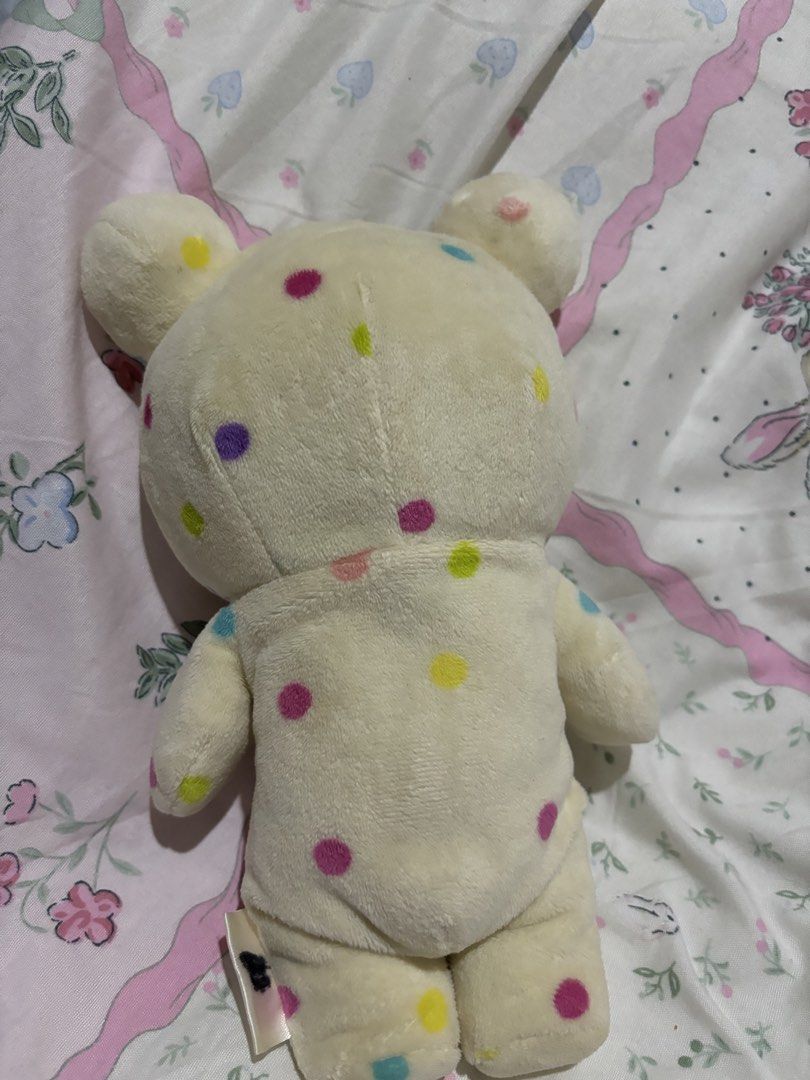 Rilakkuma Bear Plush Toy (Category: Plushies & Soft Toys) located in Manila. Submitted by meloopsy (Listing ID 1422896374, Image 2). Description: - Adorable Rilakkuma bear plush toy. - Features a polka-dot onesie with a rainbow design. - Brown-faced bear with a hood. - Soft and cuddly material. - Perfect for collectors or as a gift. - Includes a tag attached at the back..