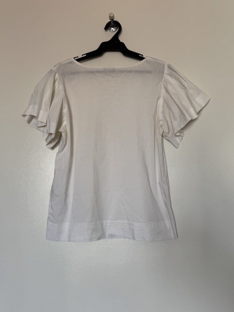 White ruffle blouse (Category: Blouses) located in Makati City. Submitted by pattystuff (Listing ID 1422763575, Image 2). Description: - White blouse with flutter sleeves - Best fit M to L - Needs washing - Pre-loved, please manage expectations.