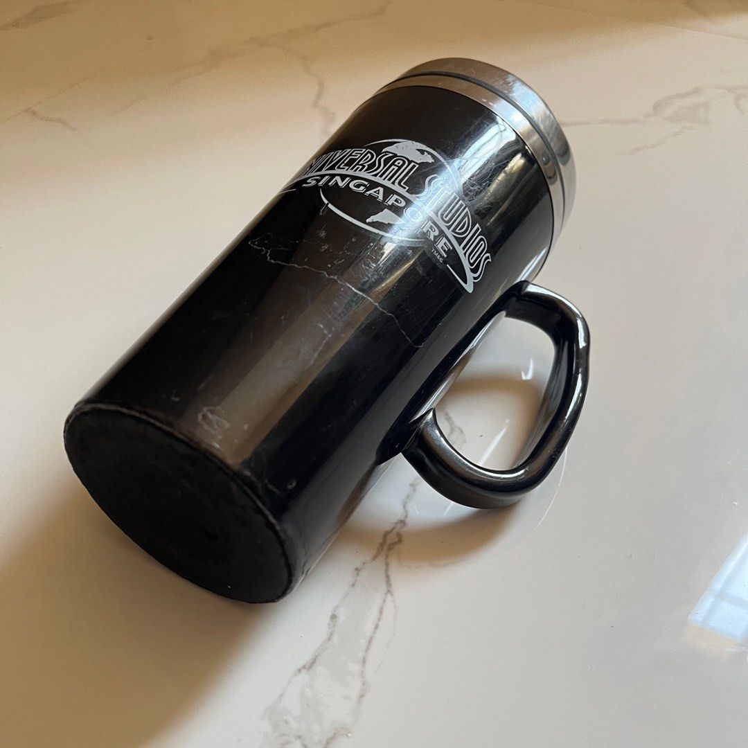 Universal Studios Singapore Travel Mug ORIGINAL (Category: Water Bottles & Tumblers) located in Taguig. Submitted by sdiph (Listing ID 1422782290, Image 2). Description: - Universal Studios Singapore travel mug souvenir, Black color - Features a handle and lid for easy carrying - Made of stainless steel - Universal Studios Singapore logo on front, Original merchandise 100%.