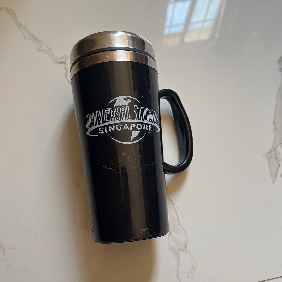Universal Studios Singapore Travel Mug ORIGINAL (Category: Water Bottles & Tumblers) located in Taguig. Submitted by sdiph (Listing ID 1422782290, Image 1). Description: - Universal Studios Singapore travel mug souvenir, Black color - Features a handle and lid for easy carrying - Made of stainless steel - Universal Studios Singapore logo on front, Original merchandise 100%.