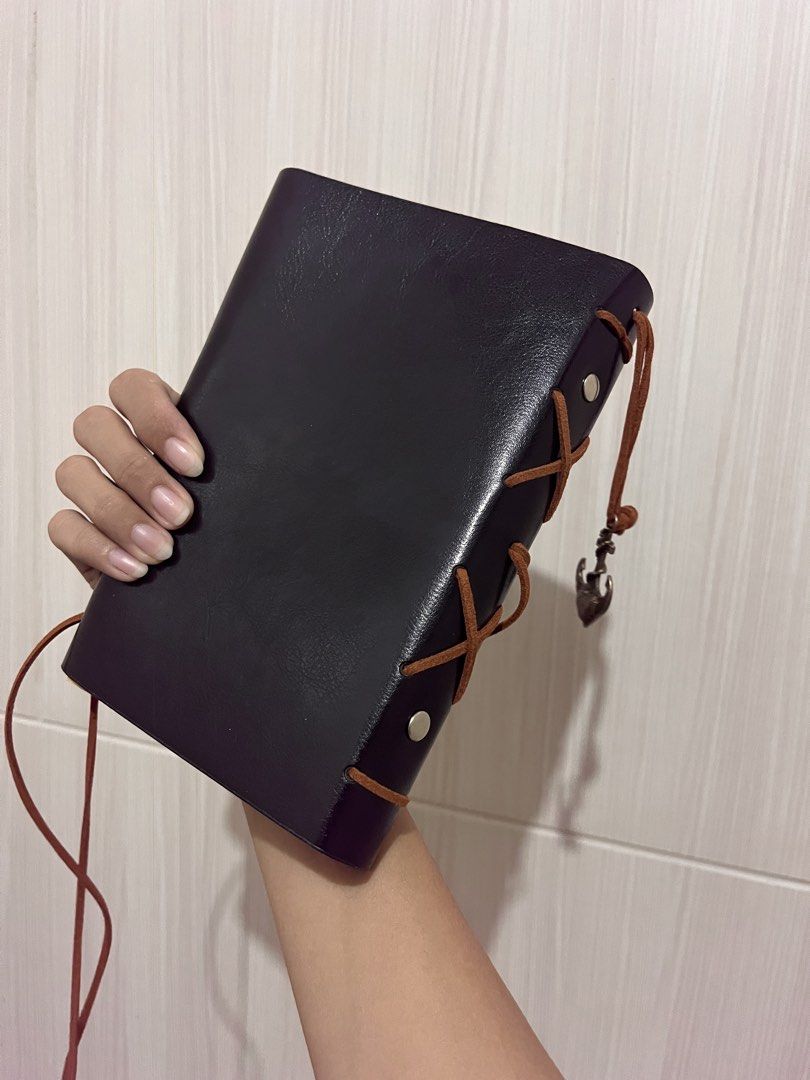 Vintage Leather Folio Journal (Category: Stationery & School Supplies) located in Manila. Submitted by marybelle.mb (Listing ID 1422727656, Image 2). Description: - Vintage-style notebook - Black leather cover with compass design and charms - Brown leather strap closure - Ring binder mechanism - Blank, cream-colored pages - Includes a storage box.