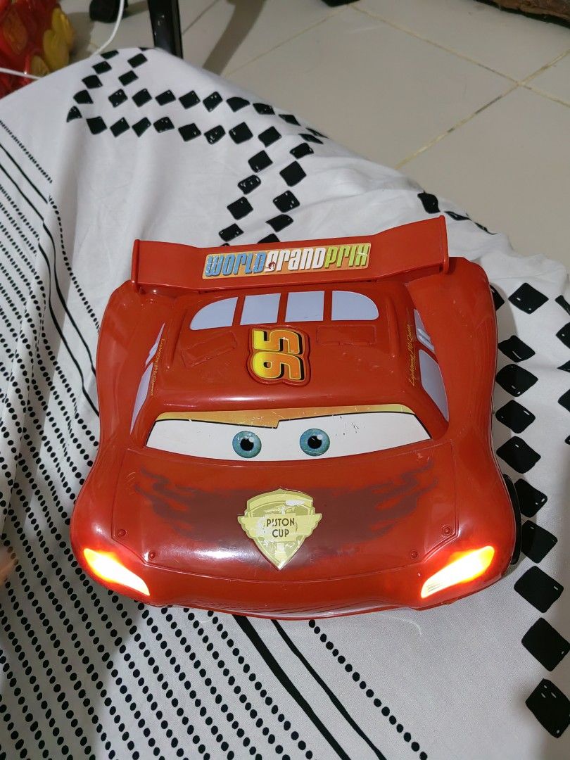 VTech Lightning McQueen Learning Laptop (Category: Laptops & Notebooks) located in Manila. Submitted by whenggsi44812 (Listing ID 1422752454, Image 1). Description: - VTech Lightning McQueen Learning Laptop - Features a screen and keyboard - Red exterior with Lightning McQueen design - Includes small car figures - Displays Cars movie characters - Shows some wear and tear.