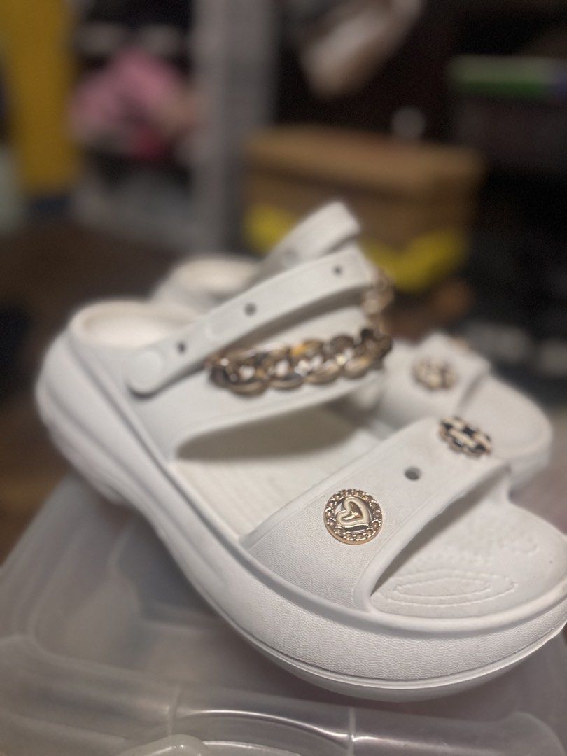 White “Crocs” Sandals with Gold Chain (Category: Flats & Sandals) located in Las Pinas. Submitted by declutterverse (Listing ID 1422871494, Image 3). Description: - White “Crocs” sandals - Gold chain and decorative charms - US size 8 / EU size 39 - Thick sole - Adjustable strap - Perfect for casual wear - Unique design.