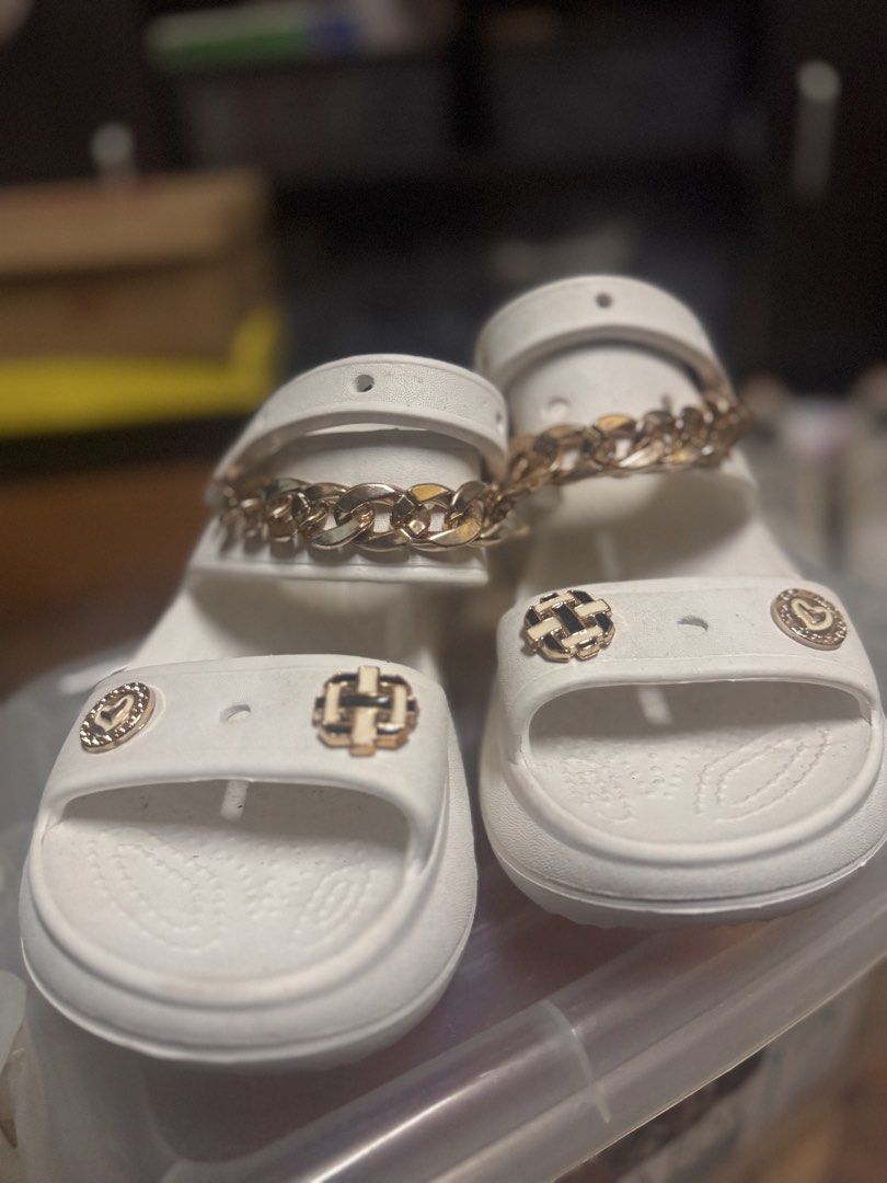 White “Crocs” Sandals with Gold Chain (Category: Flats & Sandals) located in Las Pinas. Submitted by declutterverse (Listing ID 1422871494, Image 2). Description: - White “Crocs” sandals - Gold chain and decorative charms - US size 8 / EU size 39 - Thick sole - Adjustable strap - Perfect for casual wear - Unique design.