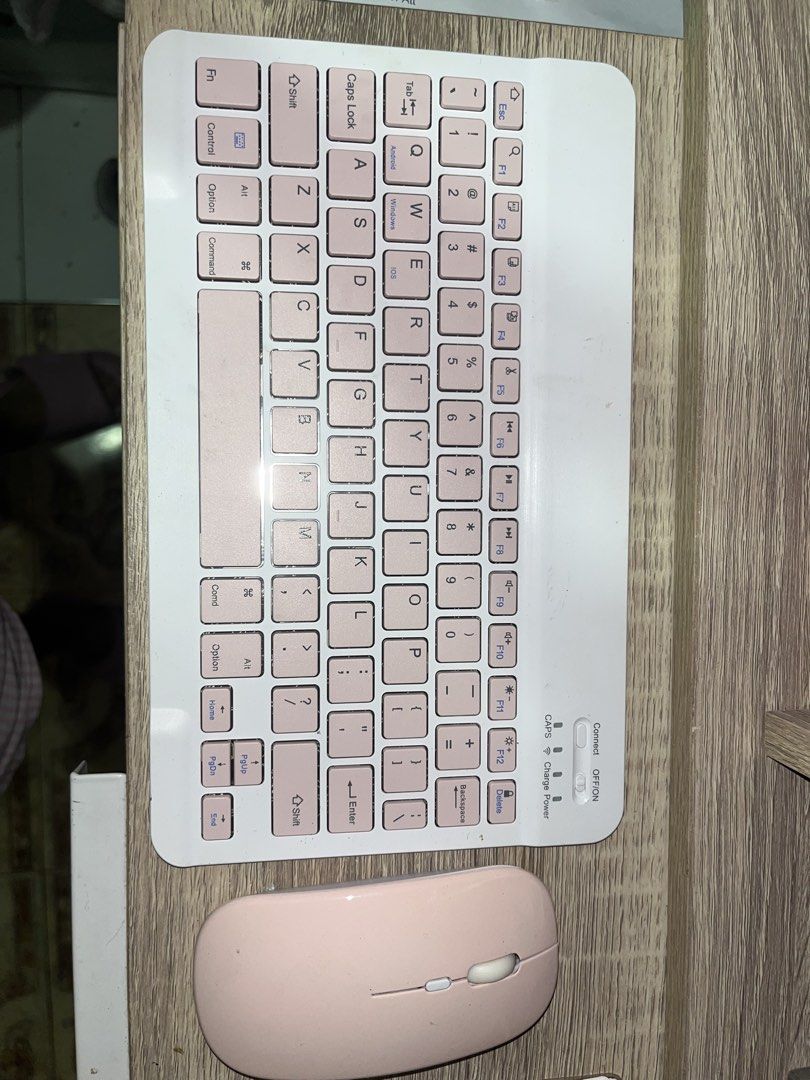 Wireless Keyboard and Mouse Set - Pink (Category: Computer Keyboard) located in Cavite. Submitted by rcamii (Listing ID 1422821120, Image 2). Description: - Stylish pink wireless keyboard and mouse set. - Keyboard features a standard layout with function keys. - Includes indicator lights for Caps Lock, charging, and power. - Mouse has a simple design with a scroll wheel and two buttons. - Designed for ease of use and portability..