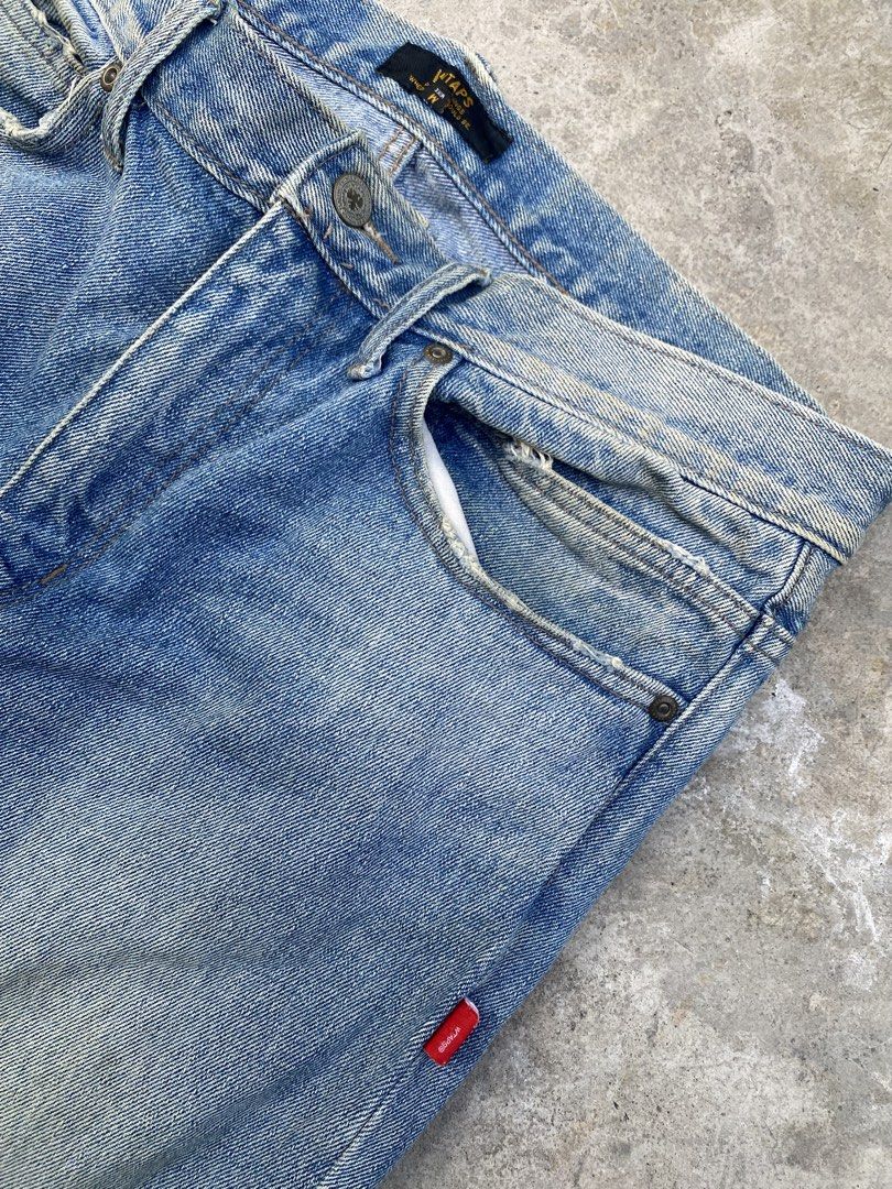 WTAPS Distressed Jeans (Category: Jeans) located in Quezon City. Submitted by yricbugayo66048 (Listing ID 1422809650, Image 2). Description: - Light blue WTAPS jeans - Distressed design - Red tag detail - Leather WTAPS logo patch - Classic five-pocket design - Straight leg fit - Faded wash on back - Size tag visible in photos.