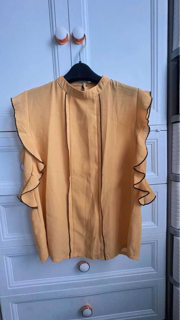 Yellow Ruffle Blouse (Category: Blouses) located in Pasig City. Submitted by cyebem (Listing ID 1422781304, Image 1). Description: - mustard yellow blouse - Black trim detailing - Ruffle sleeves - Round neckline - Button closure at back - Lightweight material - Perfect for warm weather - Versatile style.