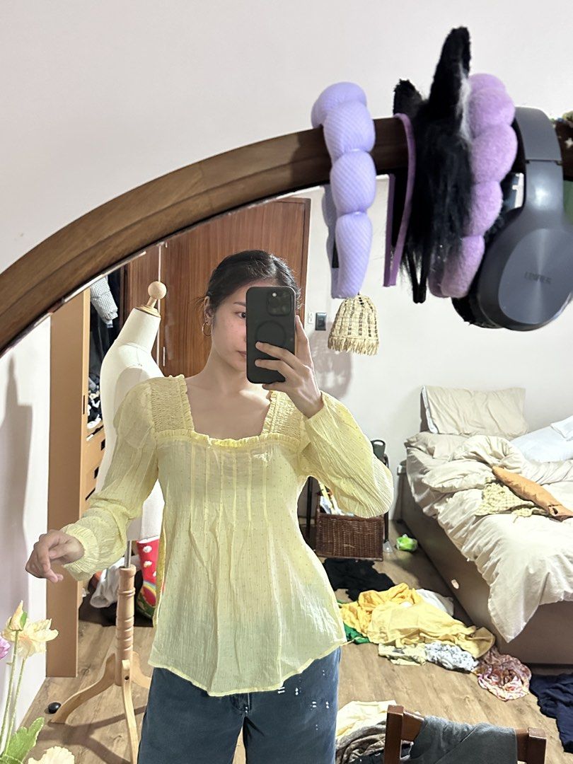 Yellow Square Neck Blouse (Category: Blouses) located in Tabuk. Submitted by classicseconds (Listing ID 1422767299, Image 2). Description: - Light yellow blouse - Square neckline - Long sleeves - Subtle dotted details - Slightly textured fabric - Relaxed fit - Lightweight material - Gathered detailing at neckline and front - Suitable for warm weather.