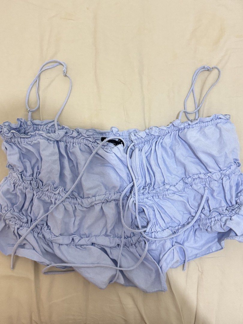 Zara Ruffled Crop Top (Category: Blouses) located in Manila. Submitted by iluvbiscoffcookie (Listing ID 1422884910, Image 3). Description: Zara light blue crop top 🩵 - Ruffled design with tie-up front - Spaghetti straps - Lightweight fabric - Perfect for a casual, summery look 🩵🩵.