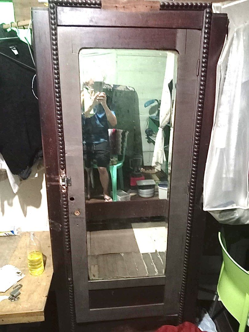 Antique Narra Wood Wardrobe with Mirror (Category: Shelves, Cabinets & Racks) located in San Juan City. Submitted by blesi (Listing ID 1422963398, Image 1). Description: - Narra material - Dark brown wooden wardrobe - Full-length mirror - Decorative trim - Door with handle and lock - Tall and narrow design - Ideal for clothes storage.