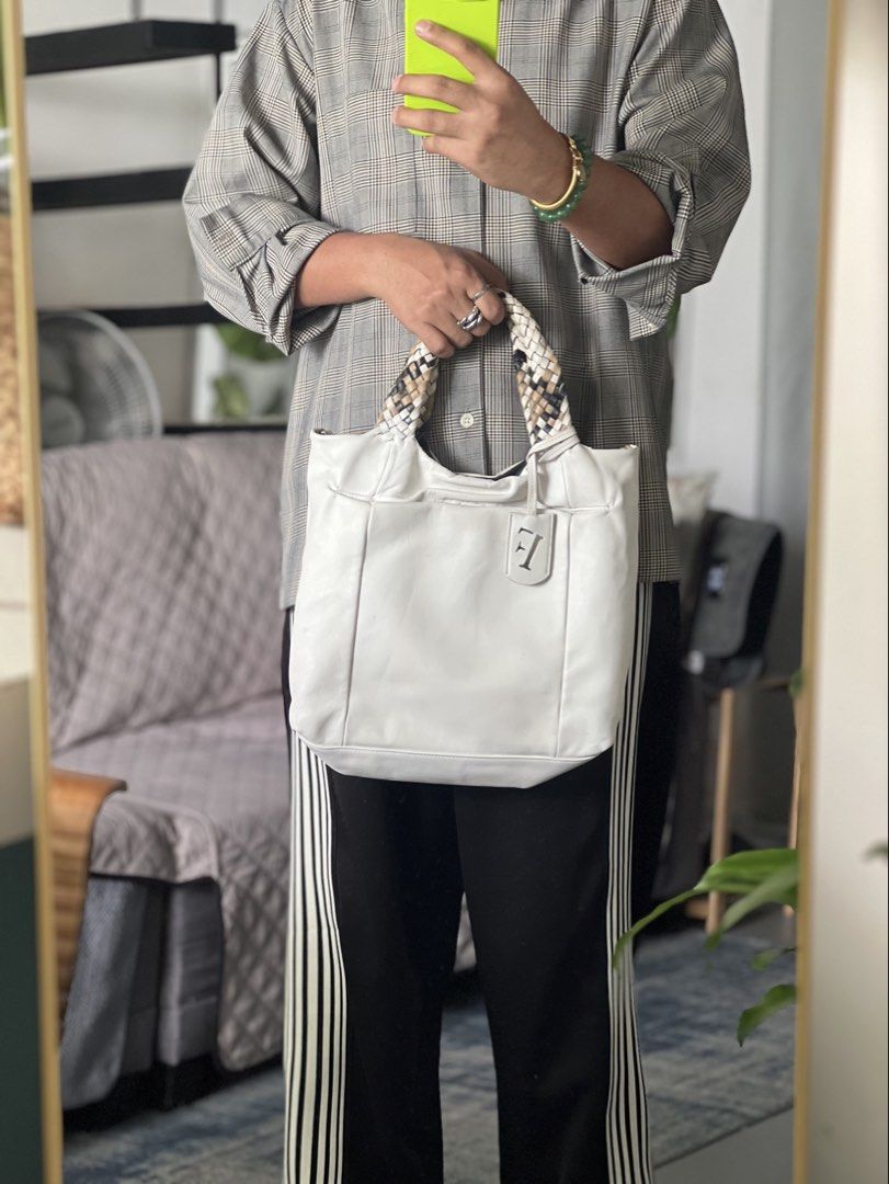 Authentic Furla White Leather Tote Bag (Category: Luxury Bags & Wallets) located in Cavite. Submitted by slumbermanila (Listing ID 1423032506, Image 1). Description: - Furla white leather tote bag - Braided handles with mixed colors - Features Furla logo tag - Patterned interior lining with small pocket - Made in Italy - Minor wear on handles This is a pre-loved item sourced from thrift finds. Kindly manage expectations, as the item shows signs o