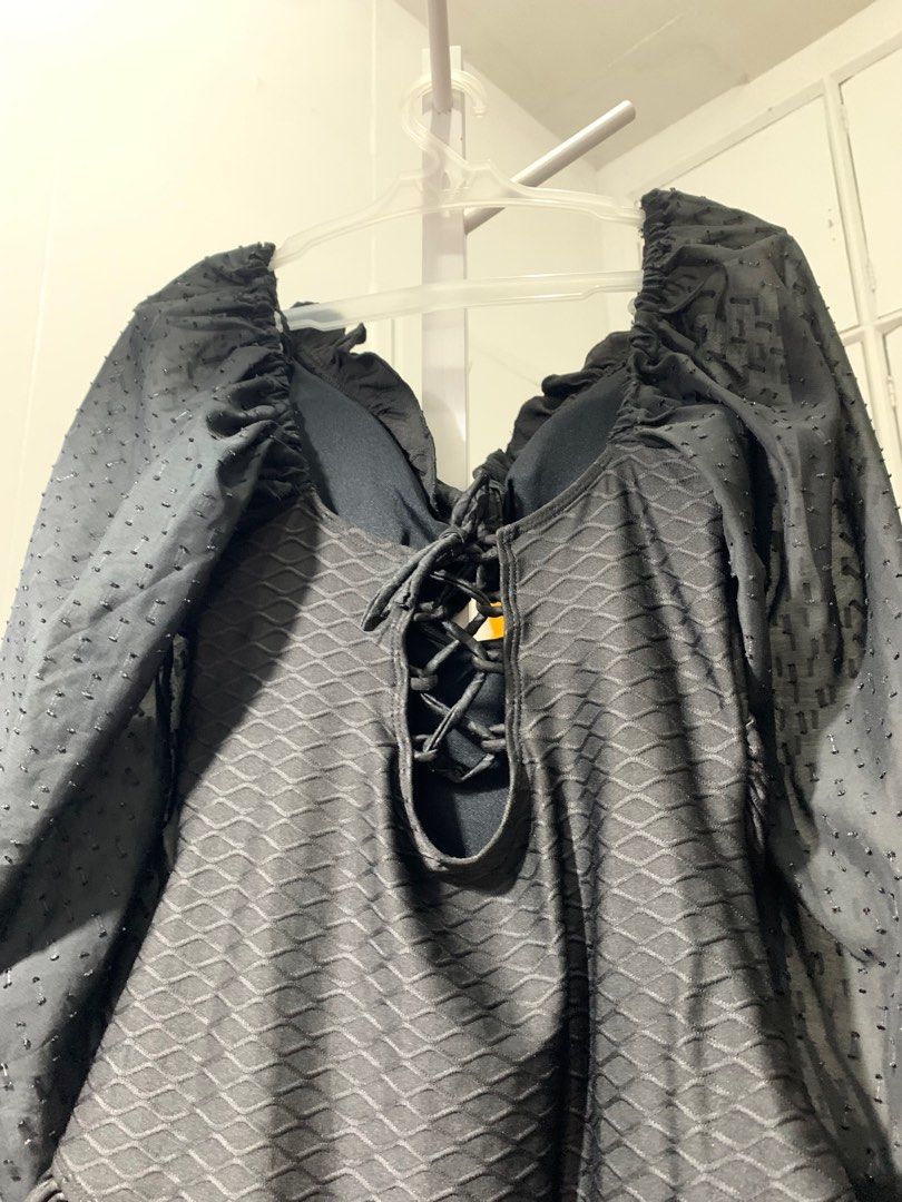 Black Long Sleeve Bodysuit/Swimsuit (Category: Others Tops) located in Quezon City. Submitted by declutterwithm (Listing ID 1423020105, Image 2). Description: - Black long-sleeved bodysuit - Textured fabric - With pads - Tie-up detail at the back - Dotted sleeves - Ruffled cuffs - Ruffled neckline - Ruffled bottom trim - Can be worn as a swimsuit.