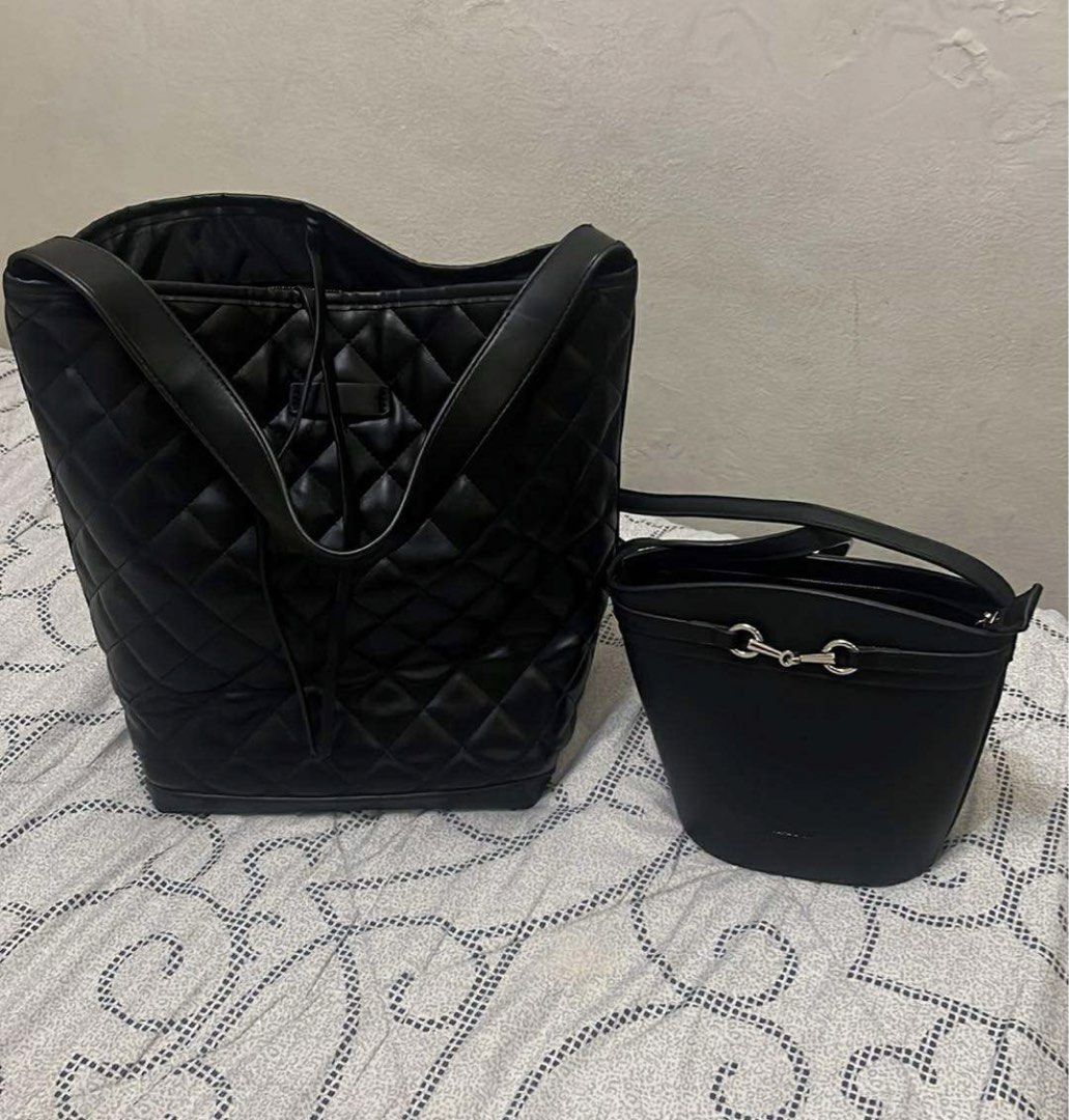 Black Quilted Bucket Bag Set (Category: Luxury Bags & Wallets) located in Manila. Submitted by 2s2knpt9nw34311 (Listing ID 1422919287, Image 1). Description: - Black bucket bag set - Includes a large, quilted bucket bag with shoulder straps - Also includes a smaller bucket bag - Smaller bag features silver-tone detail - Both bags have shoulder straps .