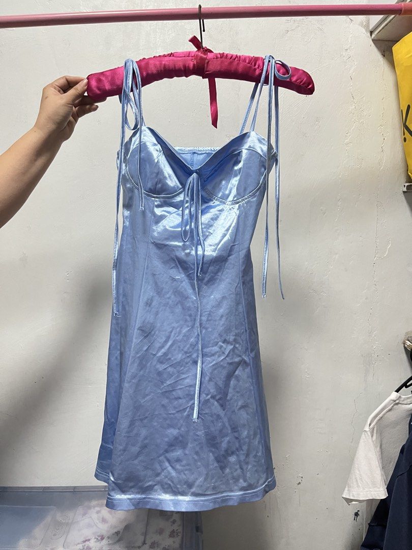 Blue Satin Mini Dress (Category: Dresses) located in Manila. Submitted by declutter_w_sam (Listing ID 1423032250, Image 1). Description: - Light blue satin mini dress - Tie straps - Tie detail at bust - White trim hemline.
