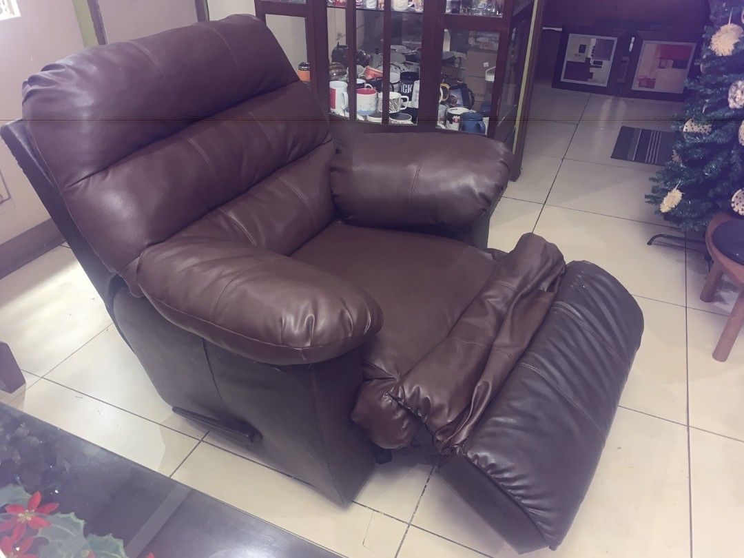 Brown Leather Recliner Chair (Category: Chairs) located in Cainta. Submitted by dondimads (Listing ID 1423080005, Image 2). Description: - Brown leather recliner chair - Padded armrests - Reclining footrest - Well-maintained leather - Classic design - Ideal for living rooms and entertainment areas.
