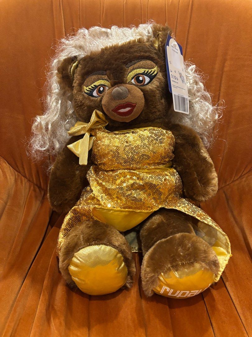 Build-A-Bear RuPaul Plush Teddy Bear (Category: Plushies & Soft Toys) located in Quezon City. Submitted by sharlene815 (Listing ID 1422911425, Image 1). Description: - Build-A-Bear RuPaul plush - Features a gold sequined dress and wig - Detailed makeup - Brown bear with blonde wig - Includes a bow - New with tag.