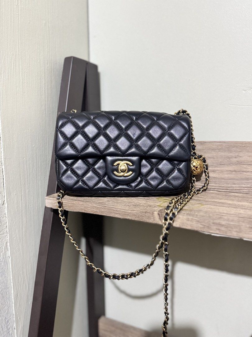 Chanel Mini rectangular pearl flap (Category: Luxury Bags & Wallets) located in Santa Barbara. Submitted by elleemmnnop (Listing ID 1423035376, Image 1). Description: - Chanel Mini rectangular pearl Flap Bag - Quilted lamb skin design - Gold-tone chain strap with ball detail - Classic CC turn-lock closure - Interior: Main compartment and zippered pocket - Made in Italy - Serial number: 25463188 - Japan sourced preloved - NGA - minor flaw on back 