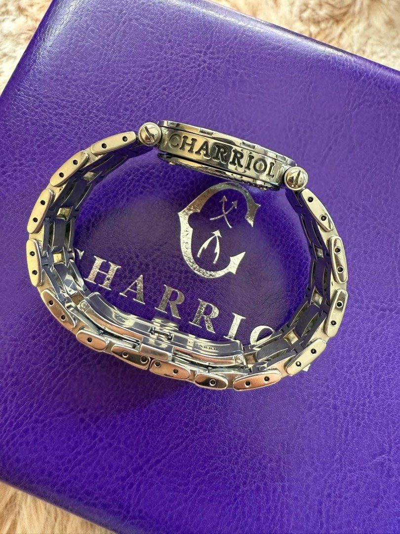 Charriol Geneva Diamond Watch 30mm (Category: Women's Watches) located in Manila. Submitted by moiluxe (Listing ID 1422946925, Image 3). Description: - Charriol Geneva watch - Diamond-studded bezel - White dial with black numerals - Date display - Stainless steel bracelet - Secure clasp - Includes original purple box - Charriol logo and details engraved on the back.