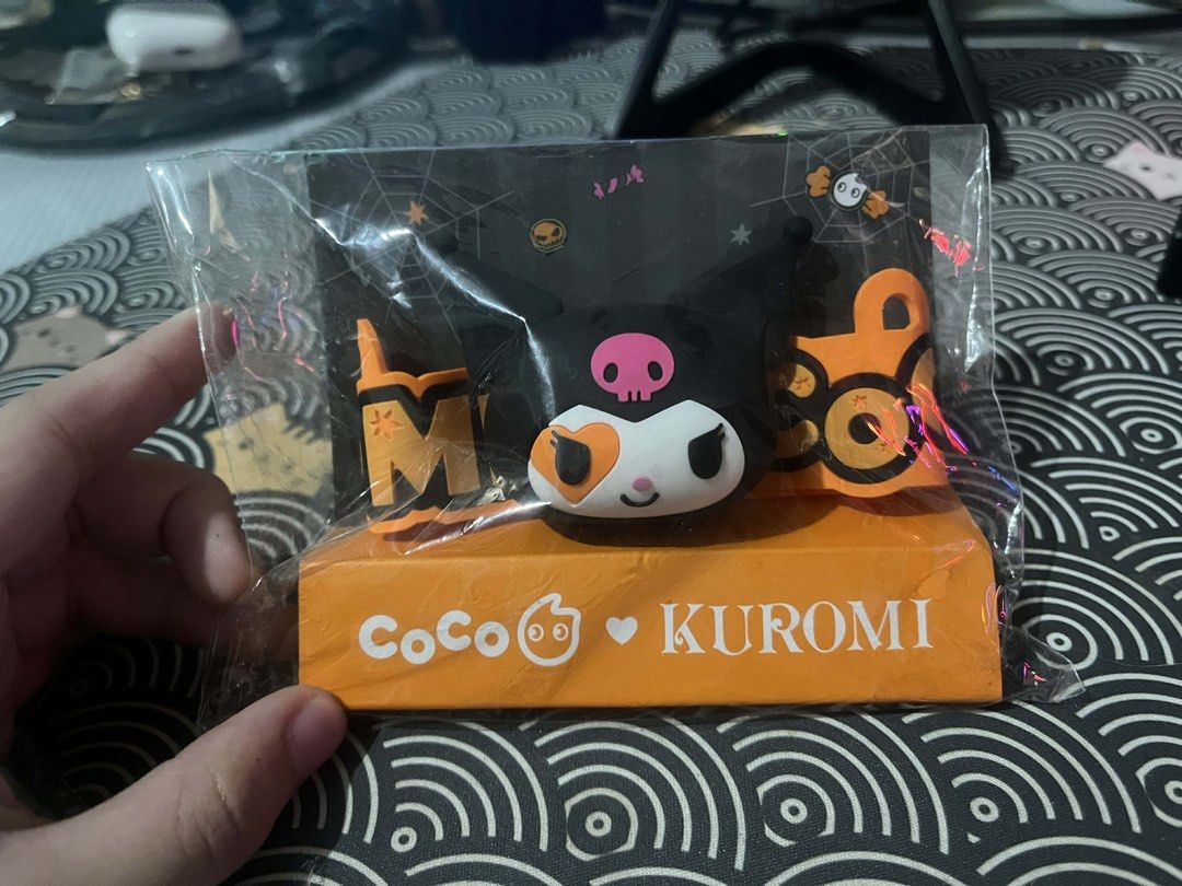 Coco x Kuromi Halloween Sling Cup (Category: Character Goods) located in Quezon City. Submitted by dee_dee213 (Listing ID 1422988921, Image 1). Description: - Coco x Kuromi Halloween Sling Cup Holder - Features Kuromi with Halloween decorations - Comes in original packaging - Orange base with Coco and Kuromi logos - Cute and collectible.