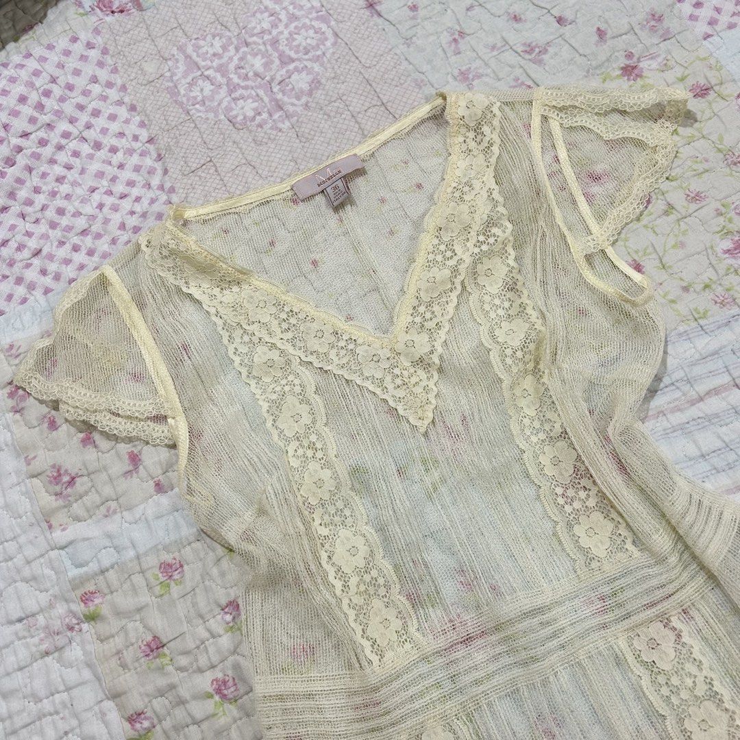 Cream See through Lace Top (coquette) (Category: Sleeveless) located in Marikina City. Submitted by naiomeww (Listing ID 1423038325, Image 2). Description: - Cream lace top (needs inner when worn) - V-neck design - Intricate lace detailing - Short, sheer sleeves - Slightly flared hem - Vintage charm.