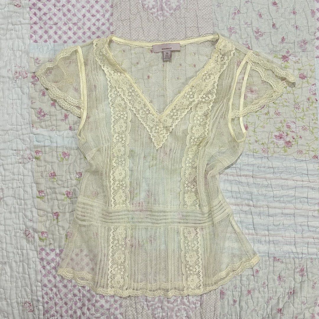 Cream See through Lace Top (coquette) (Category: Sleeveless) located in Marikina City. Submitted by naiomeww (Listing ID 1423038325, Image 1). Description: - Cream lace top (needs inner when worn) - V-neck design - Intricate lace detailing - Short, sheer sleeves - Slightly flared hem - Vintage charm.