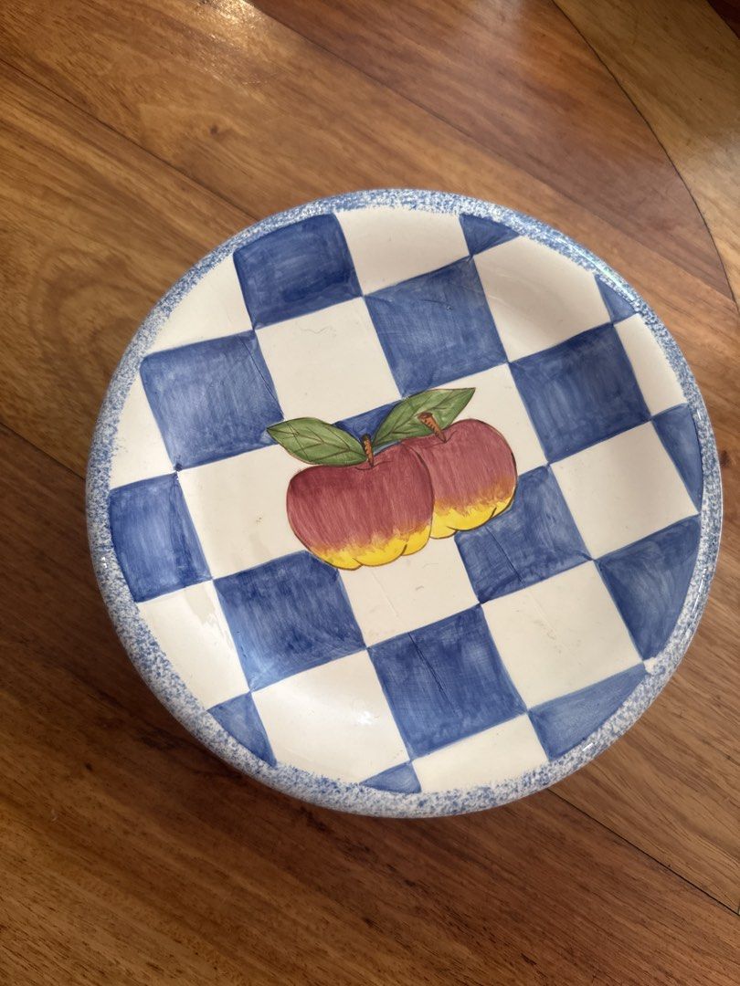 Decorative Apple Plate (Category: Dinnerware & Cutlery) located in Manila. Submitted by declutterkween14 (Listing ID 1422940856, Image 1). Description: - 12 Decorative plate with apple design. - Features a blue and white checkered background. - Includes a blue speckled border. - Medium size, ideal for serving snacks or display. - A unique addition to your kitchen or dining area..