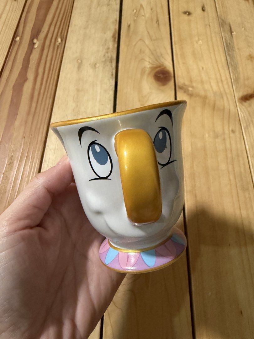 Disney Mini Tea Cup (Category: Dinnerware & Cutlery) located in Lipa City. Submitted by lifestyled (Listing ID 1422912665, Image 1). Description: Disney Beauty and the Beast Mini Chip Tea Cup, a sculpted ceramic collectible designed to resemble the character Chip from the movie. Features: It is a white tea cup with painted facial features, a gold handle, and a pastel-striped pedestal base. Bought from Disney Japan 💯Authentic .