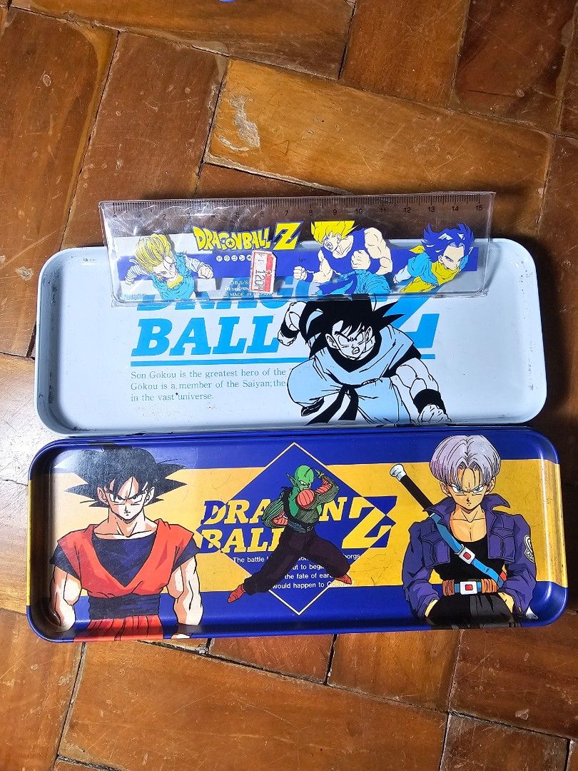 Dragon Ball Z Pencil Case with Ruler (Category: Stationery & School Supplies) located in General Santos City (Dadiangas). Submitted by pactoderetro (Listing ID 1422930962, Image 2). Description: - Dragon Ball Z pencil case - Features Goku, Trunks, and other characters - Includes a matching ruler - Rectangular metal case - Blue exterior design - White interior with Goku design.