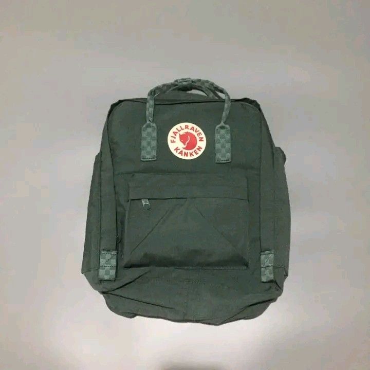 Fjallraven Kanken Backpack - Green (Category: Backpacks) located in Calbayog City. Submitted by taking-candy.ph (Listing ID 1422911904, Image 2). Description: - Authentic Fjallraven Kanken backpack - Stylish green color - Iconic Fjallraven logo patch - Checkered detailing on straps - Main compartment - Front zippered pocket - Side pockets - Interior name and address tag - Durable zipper with Fjallraven logo - Made in Vietnam.