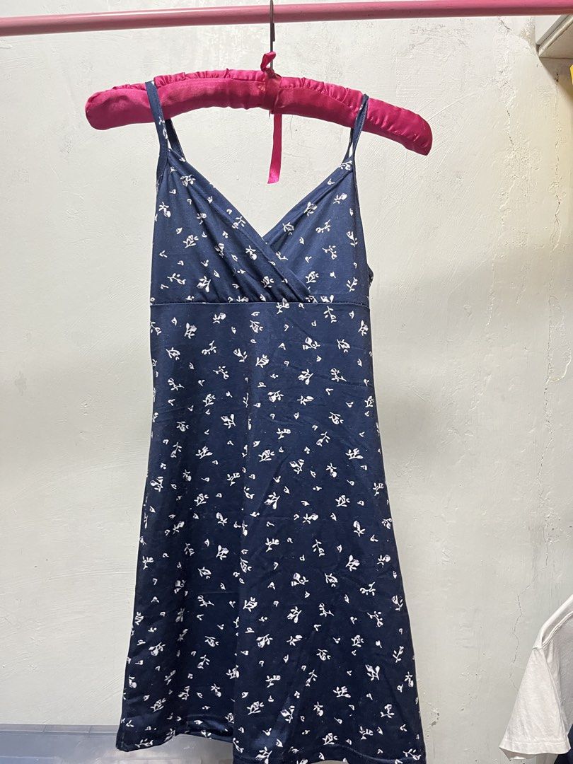 Floral Navy Dress (Category: Dresses) located in Manila. Submitted by declutter_w_sam (Listing ID 1423032111, Image 1). Description: - Navy dress with white floral print - Features a V-neckline - Spaghetti straps - Made of soft, flowing fabric - Simple and elegant design - Suitable for various occasions.