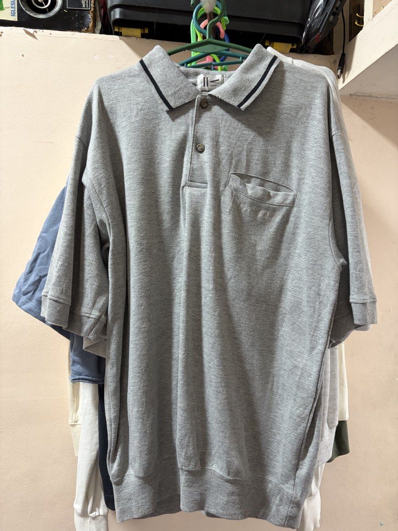 Gray Polo Shirt with Pocket (Category: Tshirts & Polo Shirts ) located in Manila. Submitted by xoffeee (Listing ID 1423001904, Image 1). Description: - Gray polo shirt - Classic collared design - Black trim on collar - Single chest pocket - Short sleeves - Relaxed fit - Comfortable, casual fabric - Ideal for everyday wear.