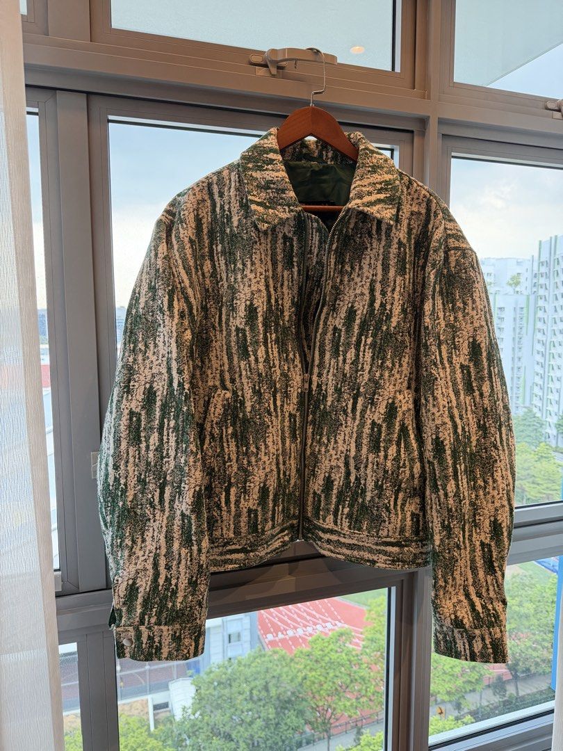Green Patterned Jacket (Category: Coats, Jackets and Outerwear) located in Singapore. Submitted by HariKishanRK (Listing ID 1422972636, Image 1). Description: Stylish jacket with a unique green and white pattern. Features a full zipper closure and a collared neckline. Perfect for adding a touch of flair to any outfit..