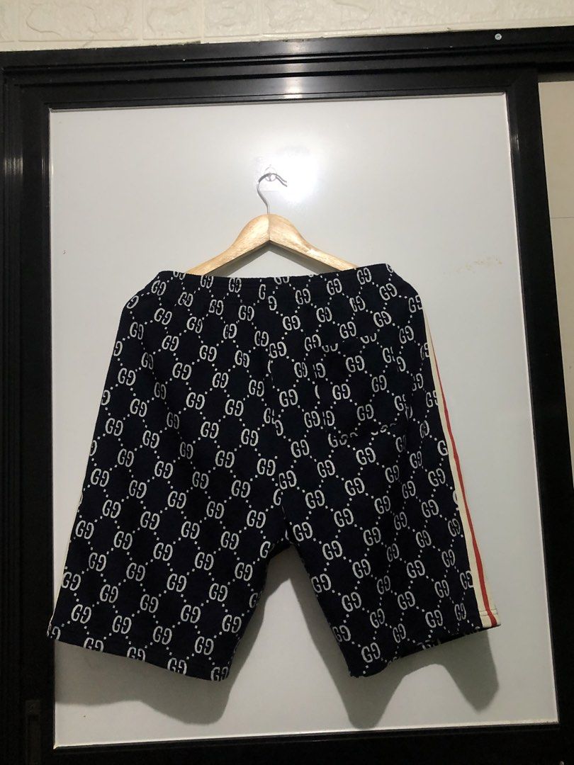 Gucci GG Pattern Shorts - Made in Italy (Category: Shorts) located in Lipa City. Submitted by deligrind (Listing ID 1423002015, Image 2). Description: - Authentic Gucci shorts - Iconic GG pattern - Navy blue base with white GG logos - Made in Italy - Red and white stripe detail - Size M - Elastic waistband.
