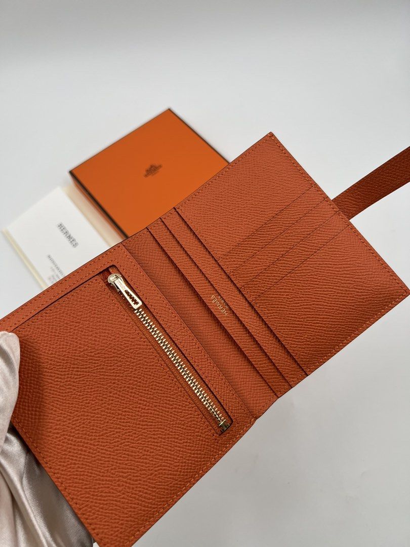 ⚜️Hermes Bearn Compact Wallet (Category: Luxury Bags & Wallets) located in Makati City. Submitted by 90sangel (Listing ID 1423062887, Image 3). Description: •Item: Hermes Wallet - Signature color 🧡 •Condition: Gently Used, Good as New! *Compact wallet in Madame calfskin✨⚜️ - Leather tab with openwork "H" closure - Zipped change purse - 4 credit card slots - 4 pockets - Bill pocket *Includes box dustbag, receipt card and paperbag *Giftable! 2 ava
