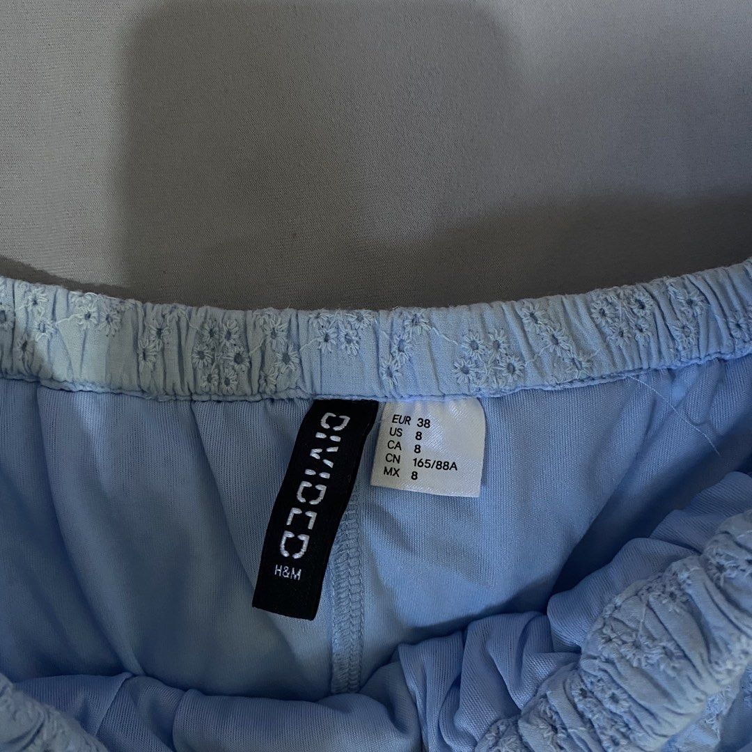 H&M Divided Off-Shoulder Dress (Category: Dresses) located in Baguio. Submitted by shoppelainee (Listing ID 1422919353, Image 2). Description: - H&M Divided dress - Off-shoulder design - Light blue color - Ruffled neckline - Flowy silhouette - Eyelet pattern - Lightweight fabric - Perfect for warm weather.