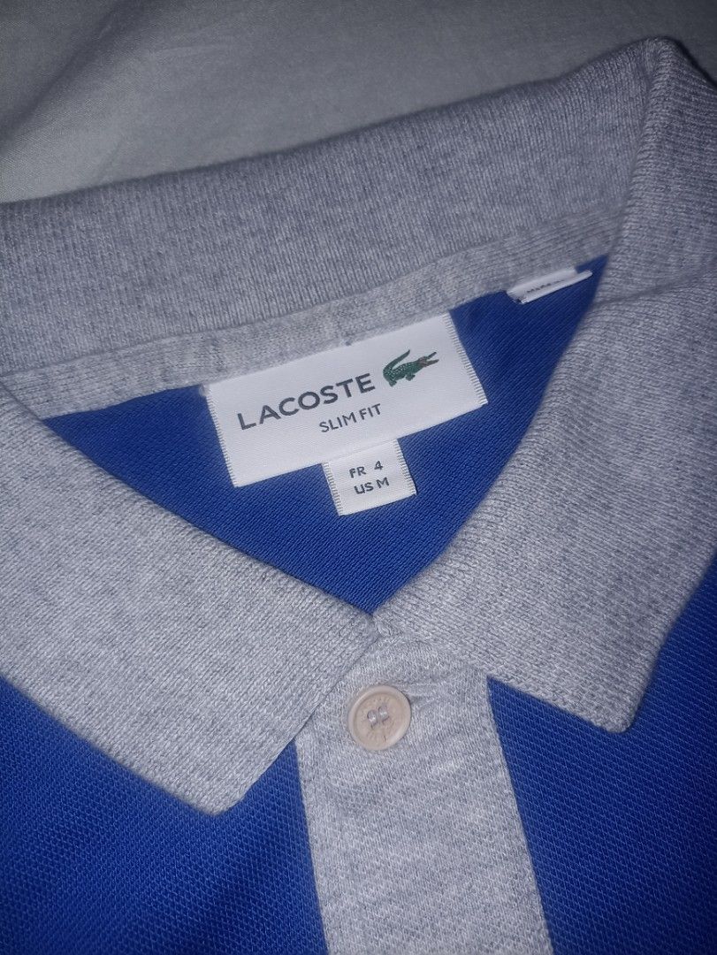 Lacoste Slim Fit Polo Shirt (Category: Tshirts & Polo Shirts ) located in Manila. Submitted by freespace01 (Listing ID 1422935483, Image 3). Description: - Lacoste Slim Fit polo shirt - Color: Blue and Grey - Features the iconic Lacoste logo - Classic polo collar and short sleeves - Size: FR 4 / US M - Versatile for casual wear.