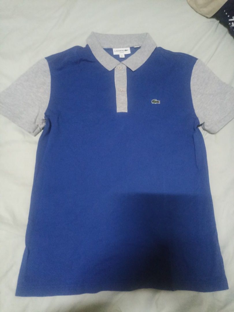 Lacoste Slim Fit Polo Shirt (Category: Tshirts & Polo Shirts ) located in Manila. Submitted by freespace01 (Listing ID 1422935483, Image 2). Description: - Lacoste Slim Fit polo shirt - Color: Blue and Grey - Features the iconic Lacoste logo - Classic polo collar and short sleeves - Size: FR 4 / US M - Versatile for casual wear.