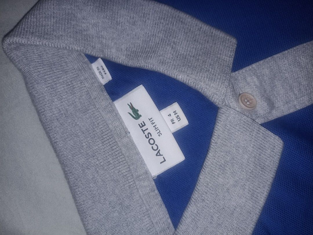 Lacoste Slim Fit Polo Shirt (Category: Tshirts & Polo Shirts ) located in Manila. Submitted by freespace01 (Listing ID 1422935483, Image 1). Description: - Lacoste Slim Fit polo shirt - Color: Blue and Grey - Features the iconic Lacoste logo - Classic polo collar and short sleeves - Size: FR 4 / US M - Versatile for casual wear.