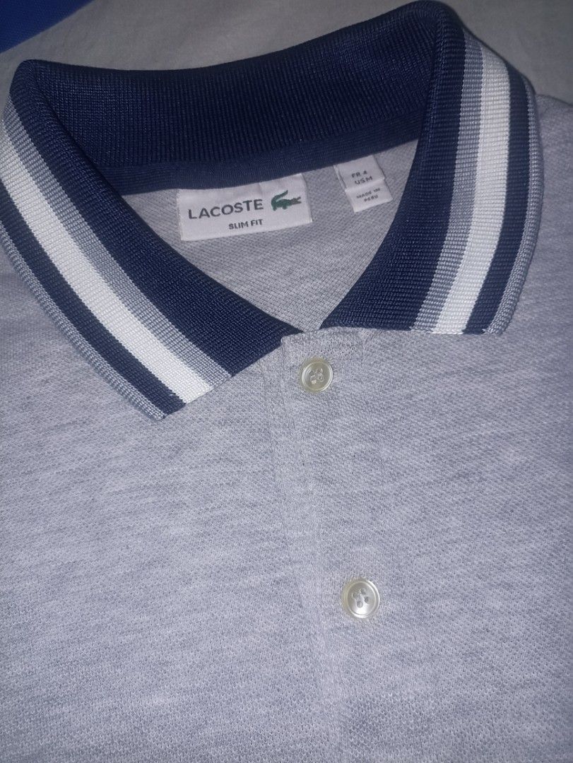 Lacoste Slim Fit Polo Shirt (Category: Tshirts & Polo Shirts ) located in Manila. Submitted by freespace01 (Listing ID 1422936098, Image 2). Description: - Lacoste slim-fit polo shirt - Color: Gray - Navy and white striped collar and sleeve cuffs - Lacoste logo on chest - Two-button placket - Made in Peru slightly used, looks good still.