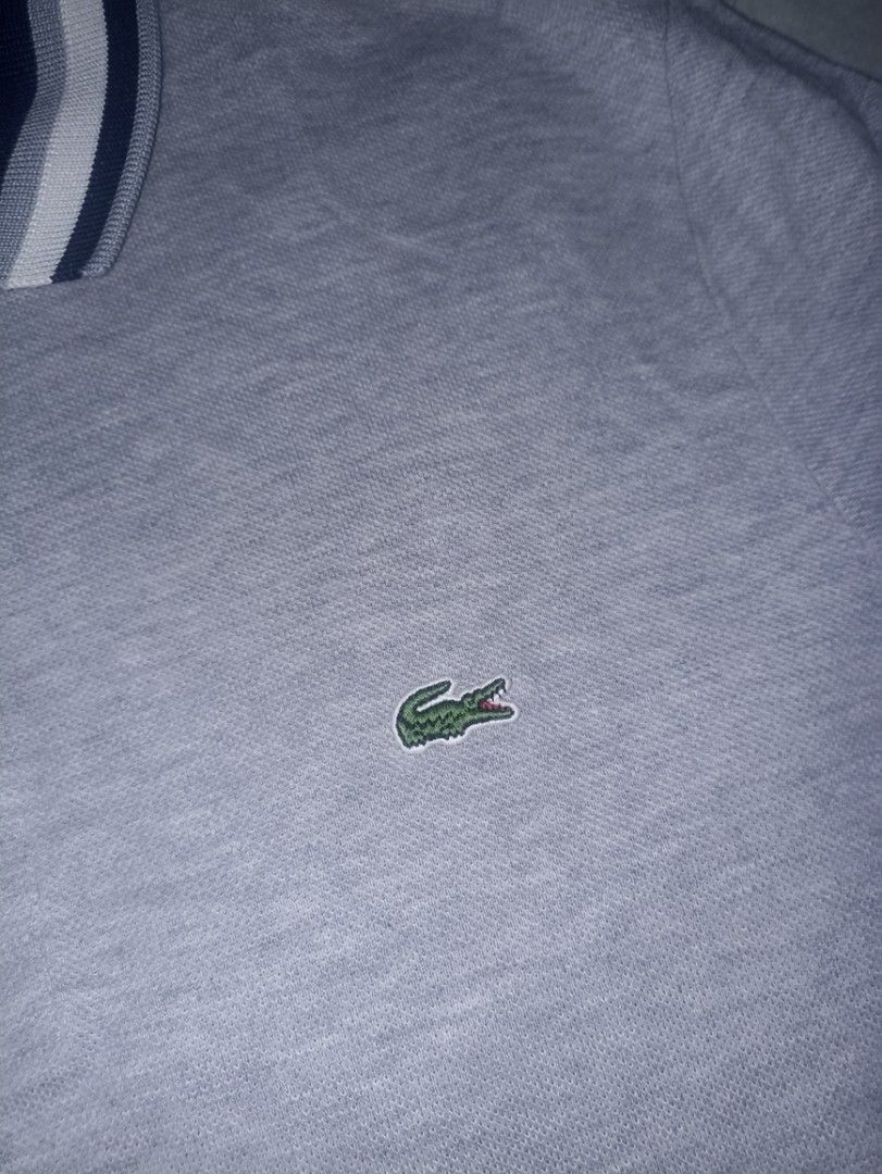 Lacoste Slim Fit Polo Shirt (Category: Tshirts & Polo Shirts ) located in Manila. Submitted by freespace01 (Listing ID 1422936098, Image 3). Description: - Lacoste slim-fit polo shirt - Color: Gray - Navy and white striped collar and sleeve cuffs - Lacoste logo on chest - Two-button placket - Made in Peru slightly used, looks good still.