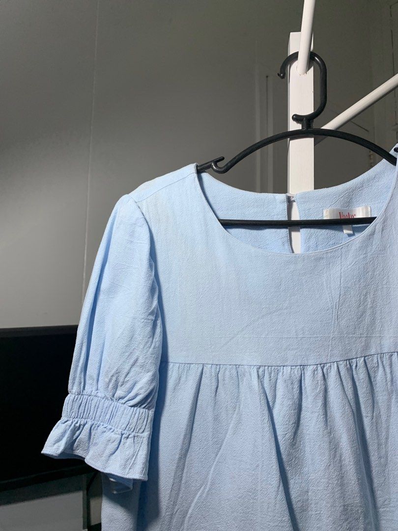 Light Blue Puff Sleeve Blouse (Category: Blouses) located in Quezon City. Submitted by declutterwithm (Listing ID 1423018757, Image 2). Description: - Light blue blouse - Square neckline - Short puff sleeves with ruffled cuffs - Gathered detail below neckline - Textured fabric.