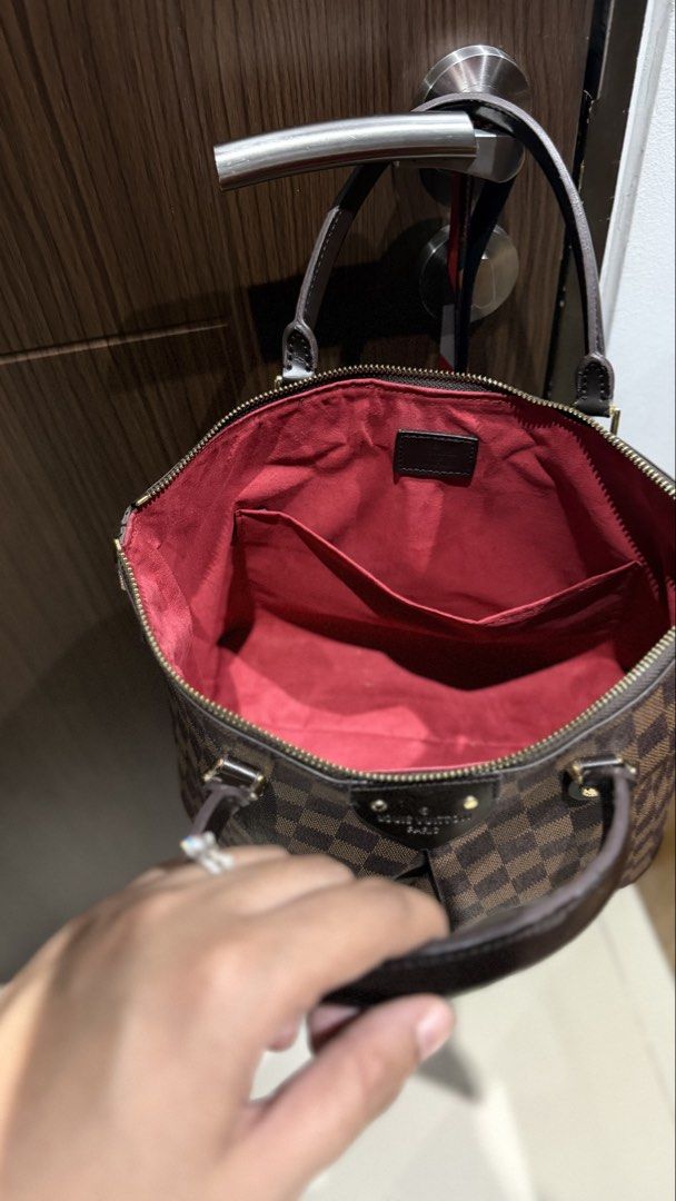 Louis Vuitton Damier Ebene MM Handbag (Category: Luxury Bags & Wallets) located in Manila. Submitted by youfinds_ (Listing ID 1423013985, Image 3). Description: - NGA Louis Vuitton Verona MM handbag - Damier Ebene canvas - Dual rolled handles - Gold-tone hardware - Top zip closure - Red fabric lining - Interior pockets - Iconic Damier Ebene pattern - Stylish everyday carry.