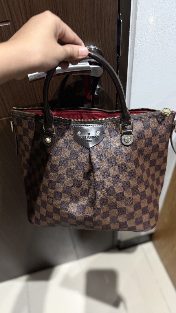 Louis Vuitton Damier Ebene MM Handbag (Category: Luxury Bags & Wallets) located in Manila. Submitted by youfinds_ (Listing ID 1423013985, Image 2). Description: - NGA Louis Vuitton Verona MM handbag - Damier Ebene canvas - Dual rolled handles - Gold-tone hardware - Top zip closure - Red fabric lining - Interior pockets - Iconic Damier Ebene pattern - Stylish everyday carry.