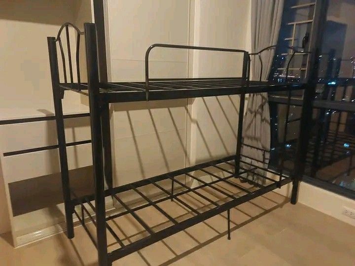 Metal Bunk Bed - Black (Category: Bed Frames & Mattresses) located in Manila. Submitted by 23kcaleon (Listing ID 1423011654, Image 1). Description: - Black metal bunk bed - Features a ladder for top bunk access - Includes safety rails - Sturdy metal frame - Ideal for shared bedrooms - Maximizes space.