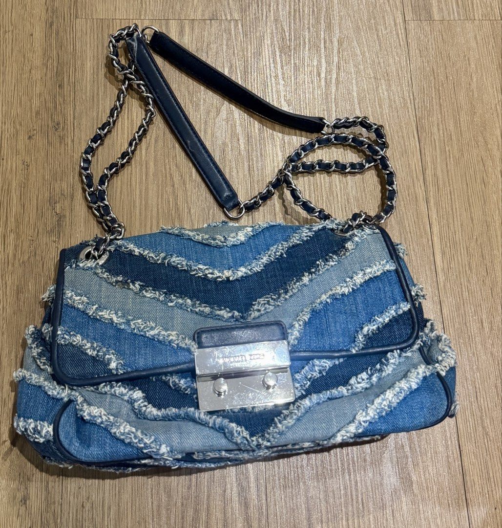 Michael Kors Denim Shoulder Bag (Category: Luxury Bags & Wallets) located in Manila. Submitted by declutterkween14 (Listing ID 1422955942, Image 2). Description: - Michael Kors shoulder bag - Denim design with chain strap - Flap closure with silver-tone clasp - Unique layered, fringed denim effect .