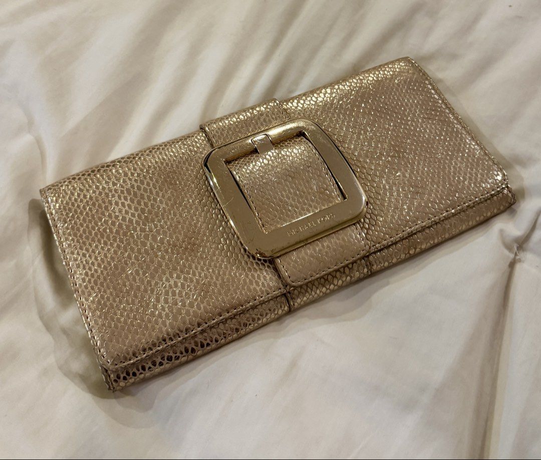 Michael Kors Gold Clutch (Category: Clutches) located in Manila. Submitted by declutterkween14 (Listing ID 1422961938, Image 1). Description: - Michael Kors gold clutch - Textured exterior - Stylish buckle closure - Secure magnetic snap .