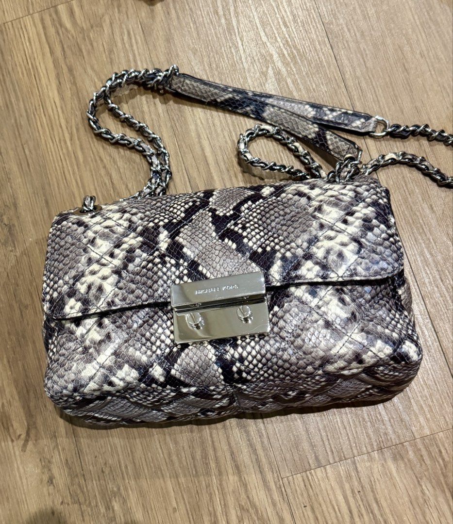 Michael Kors Snakeskin Shoulder Bag (Category: Luxury Bags & Wallets) located in Manila. Submitted by declutterkween14 (Listing ID 1422956520, Image 1). Description: - Michael Kors shoulder bag - Snakeskin pattern - Silver-tone clasp - Chain strap with leather shoulder rest - Quilted design - Michael Kors logo visible.