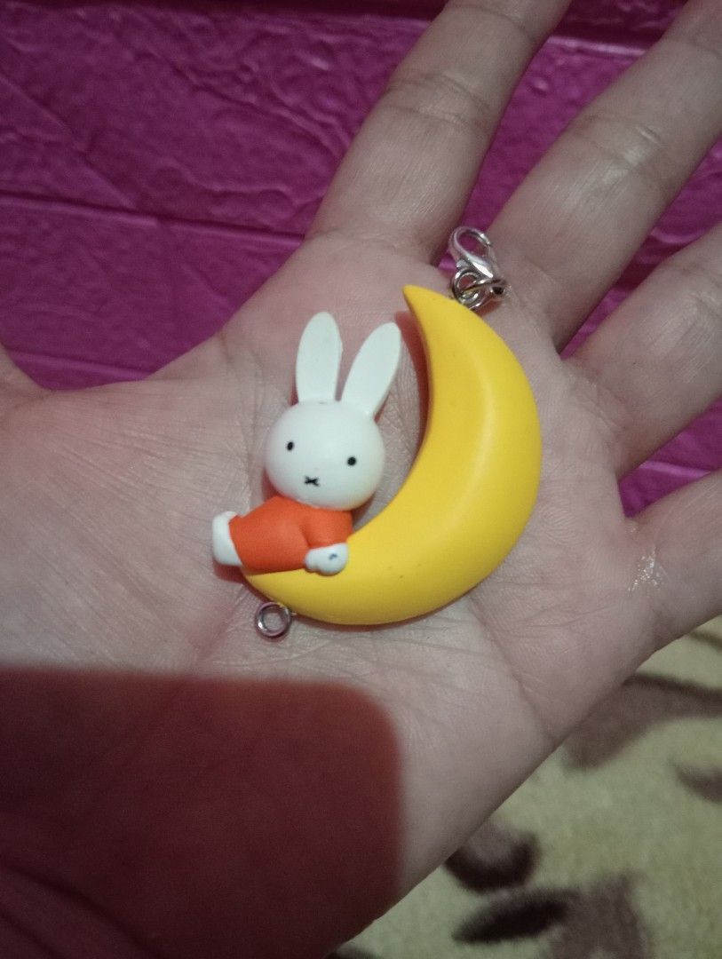 Miffy on the Moon Keychain (Category: Character Goods) located in Bulacan. Submitted by renasophiatoystore2020 (Listing ID 1423048630, Image 1). Description: - Adorable Miffy keychain - Features Miffy sitting on a yellow crescent moon - Includes a silver clasp and small ring - Moon's back has Miffy logo and "Mercis bv, Made in China" - Great accessory for keys or bags!.