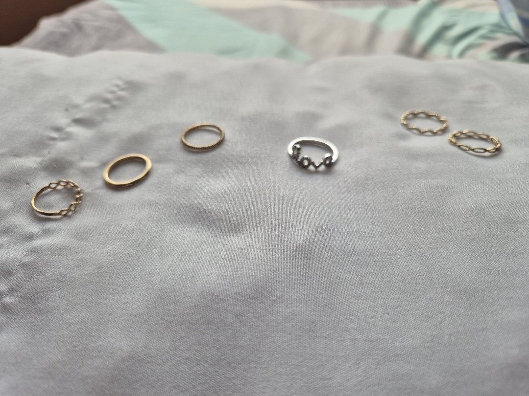 Minimalist Jewelry Gold Colored Ring Set (Category: Rings) located in Pasig City. Submitted by joejoejoes (Listing ID 1423046803, Image 1). Description: Class A Rings (Left to Right): 1. infinity ring, often stylized as a chain link or infinity motif ban (1.5cm inner diameter) 2. solid gold colored band, crafted with a textured, molten, or hammered finish (1.5cm inner diameter) 3. minimalist twisted rope design ring (1.5 cm inner diameter) 4. ste